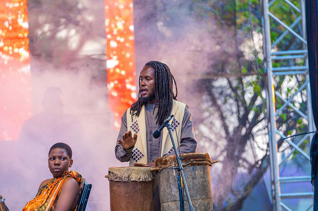 Percussionist performing through stage smoke