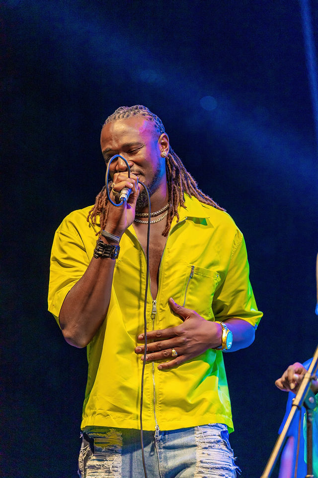Singer in a bright shirt performing live
